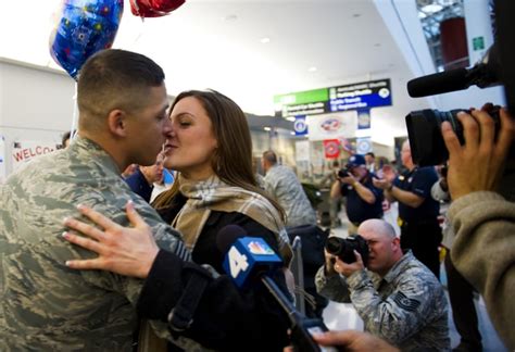 a couple shared a not so private kiss upon the return home of the 300 soldier homecoming