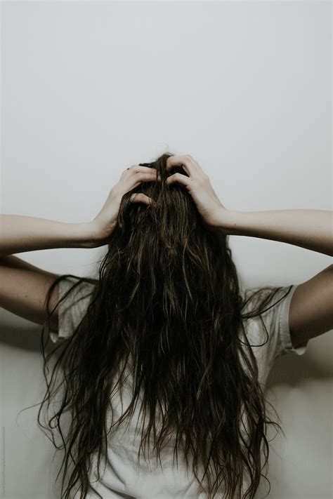 View Stressed Out Woman With Hair Covering Her Face In Front Of A