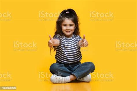 Portrait Of Cute Little Smiling Arab Girl Showing Thumbs Up At Camera