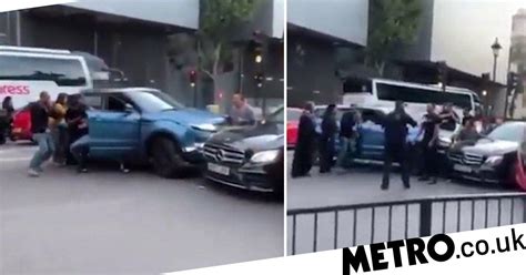 shocking moment woman crushed between two cars in road
