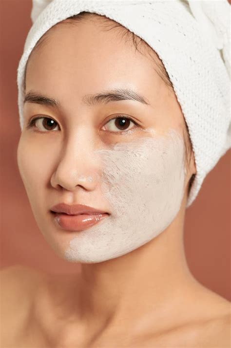 spa asian girl applying facial clay mask beauty treatments  blue