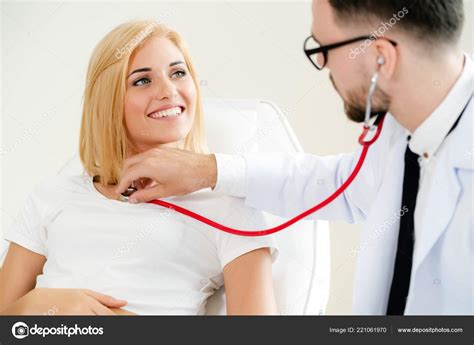 Male Doctor Talking Examining Female Patient Hospital Office Healthcare