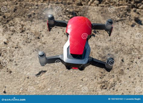 small sized red drone  high resolution camera hovering  air  aerial photography stock