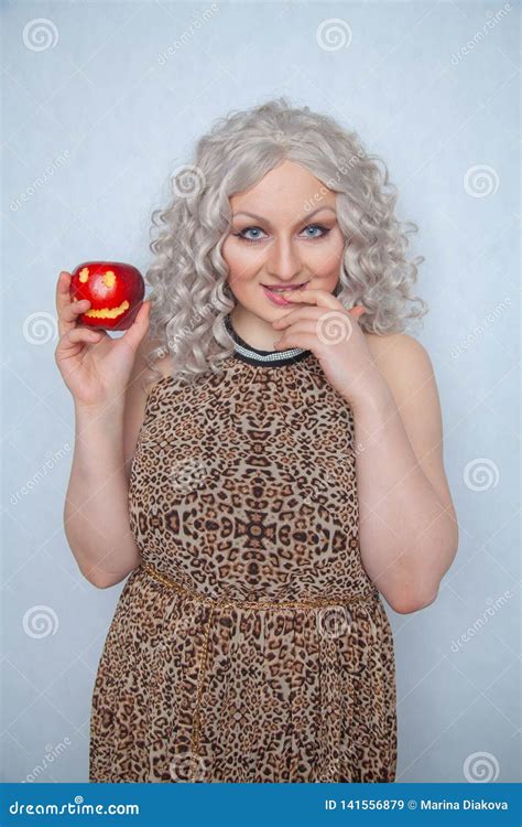 Chubby Blonde Girl Wearing Summer Dress And Posing With Big Red Apple