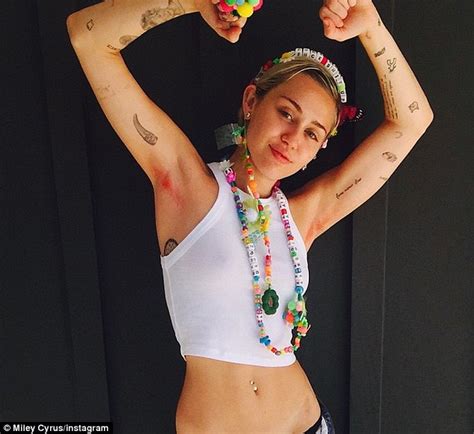 miley cyrus strips down to show off her bright pink arm pit hair on