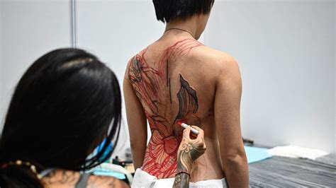 malaysian minister criticises obscene half naked tattoo show in