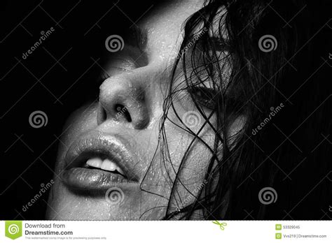 wet woman portrait with water drops on the face black and white stock