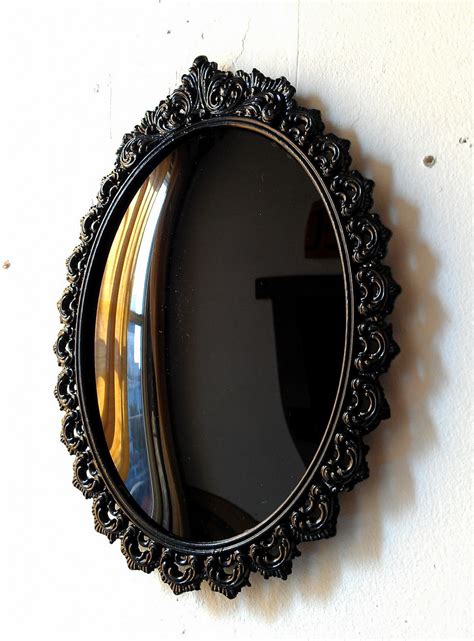 black convex scrying mirror  vintage oval frame