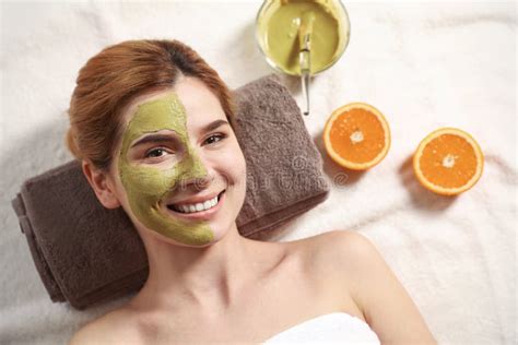 Beautiful Woman With Mask On Face Relaxing In Spa Salon Stock Image