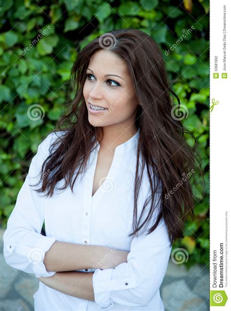 beautiful brunette outdoors in the park thinking stock