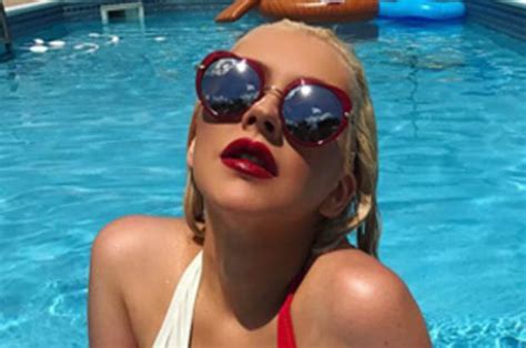christina aguilera strips to one piece for independence day peepshow
