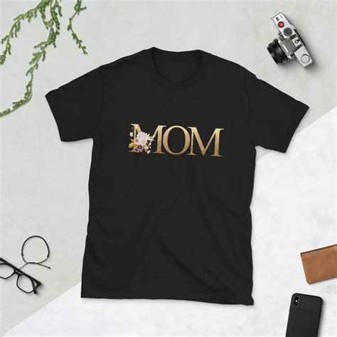 short sleeve black t shirt on a white table top with gold glitter ombre