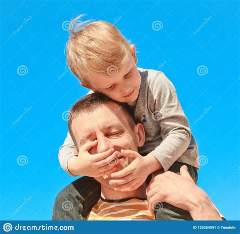 child shoulders father plays hands closing eyes stock image image