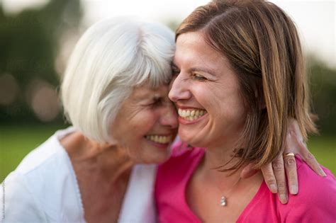 Senior Mother And Mature Daughter Laughing And Hugging By Stocksy