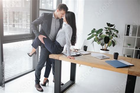 Sexual And Intimate Picture Of Couple At Work She Sit On Table He
