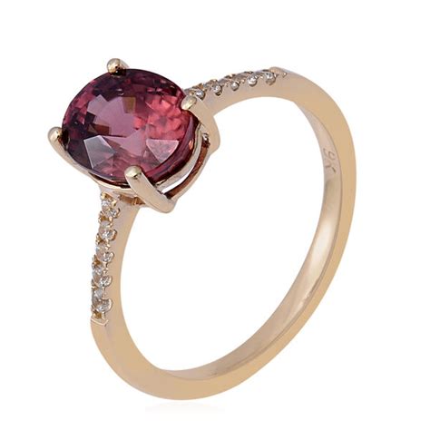 tanzanian rose zircon and white zircon solitaire ring in 9k yellow gold