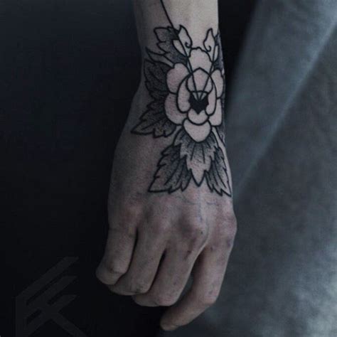 Simple Black Flower Tattoo Inked On The Right Hand Hand Tattoos