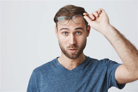 Free Photo Surprised Man Take Off Glasses And Stare Confused