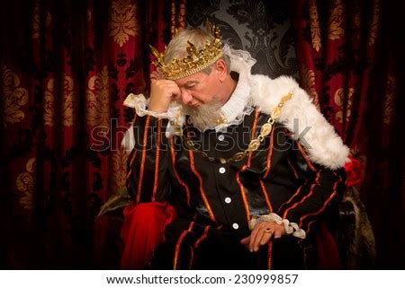 pensive  worried king sitting   throne stock photo