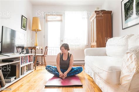 real woman  yoga exercise  home living room stock photo