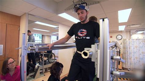 paralyzed man walks  assistance     therapy