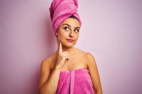 Young Beautiful Woman Wearing Towel After Shower Over Isolated Pink