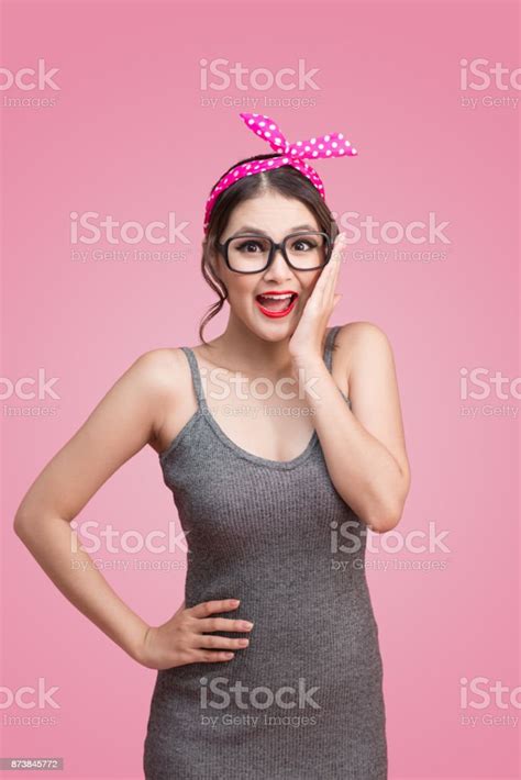 surprised asian girl with pretty smile in pinup makeup style stock