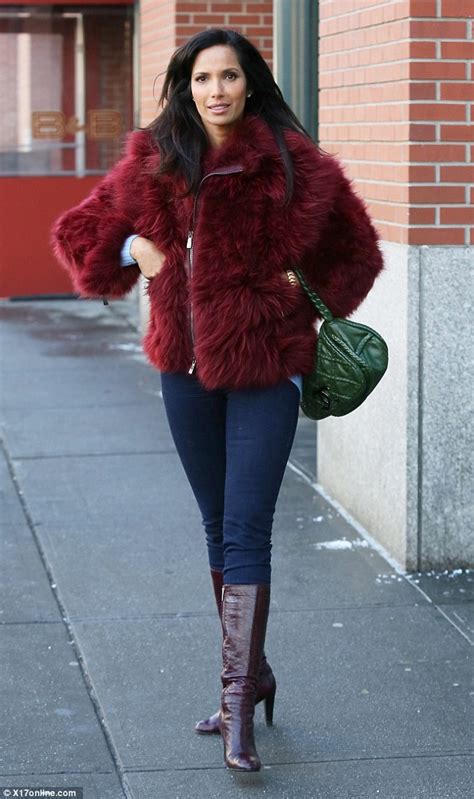 padma lakshmi teams a chic fluffy claret coat with skinny jeans and
