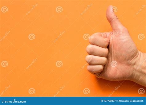 hand   man   thumb    orange background stock image image  sign human