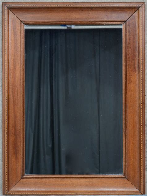 een rechthoekige spiegel  houten lijst versierd met sober inlegwerk jordaens nv veilinghuis