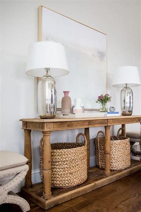 beige  stools flank  reclaimed wood console table fitted