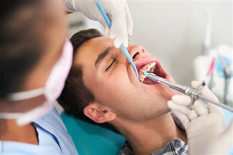 dental patient receiving  injection  anesthesia   dentist  stocksy contributor
