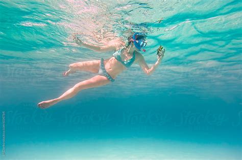Woman Wearing Bikini Underwater Snorkeling At Blue Clear Caribbean