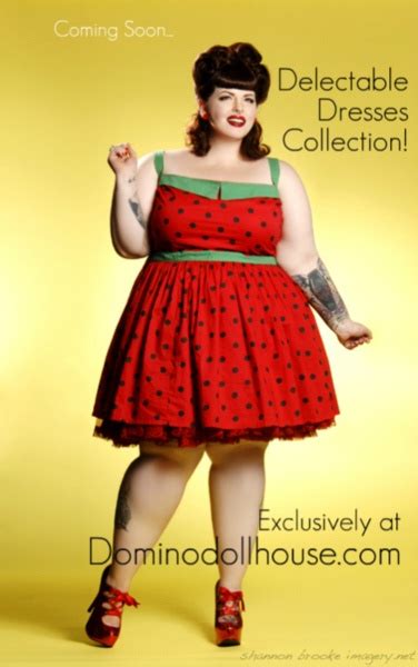 A Woman In A Red Polka Dot Dress Posing For The Camera With Her Hands