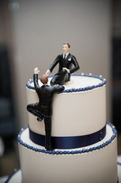 cake topper one male on top of the cake the other climbing up to him sweet gay wedding