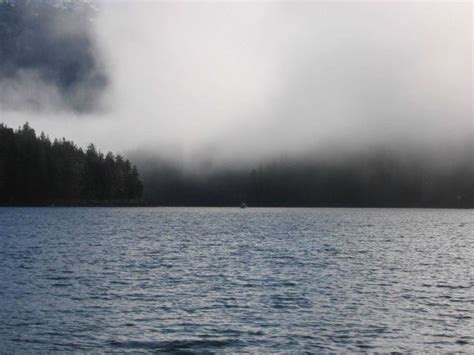sounding boat     distance  fog shrouded hills photo pictures images