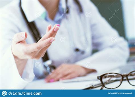 Female Doctor Explaining Patient Symptoms Or Asking A