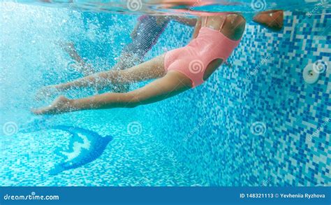 underwater image of two teenage girls diving and swimming underwater at