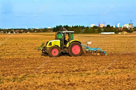 tractor plowing  field stock photo  hackman