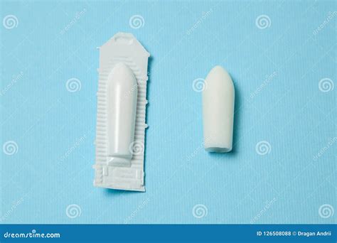 suppository for anal or vaginal use on a blue background candles for