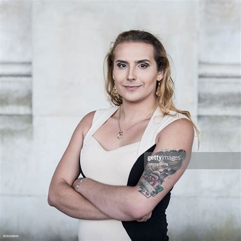 Transgender Female With Tattoo On Arm Looking Towards