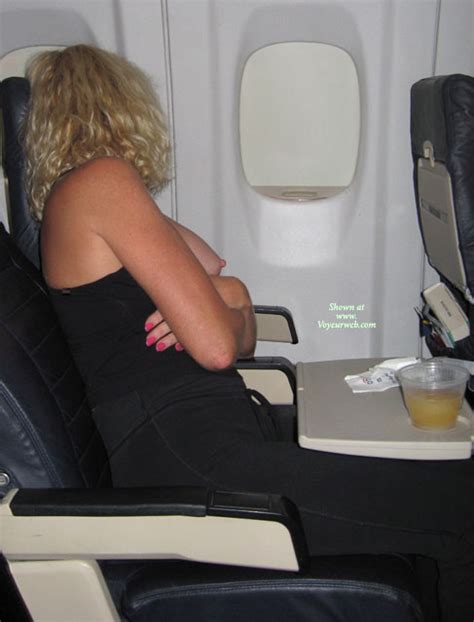 naughty blond with curls exposing tits on an airplane february 2008 voyeur web hall of fame