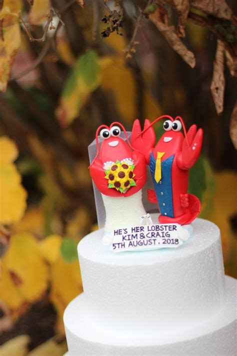 a clay lobster couple wedding cake topper raced dress on the bride