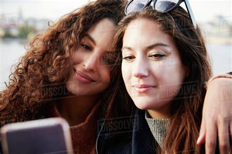 Lesbian Couple Taking Selfie With Mobile Phone In City