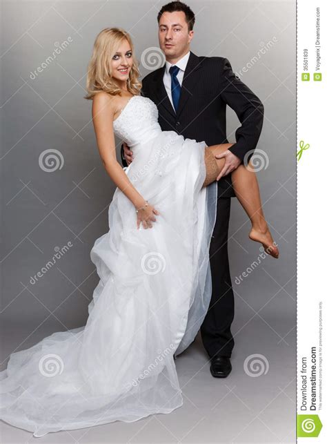 happy married couple bride groom on gray background stock