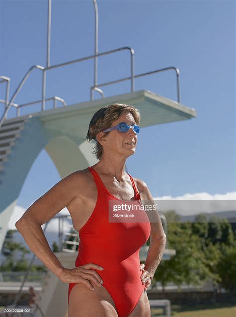 Mature Woman Wearing Swimsuit And Swimming Goggles Outdoors