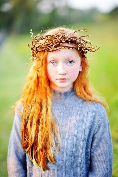 looks as tho there are some pussy willow branches woven into a crown for a lovely red haired