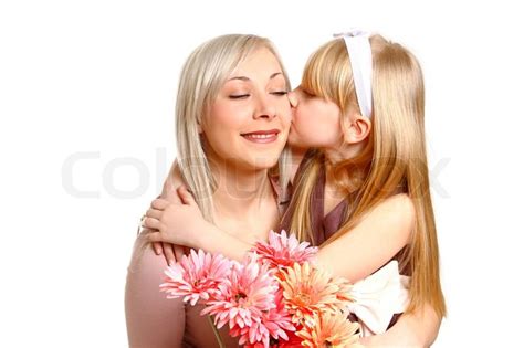 daughter giving flowers and kissing her mother isolated on white