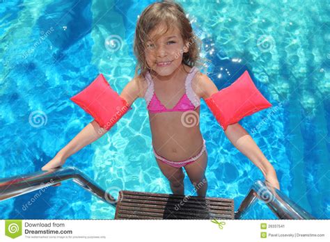 małej dziewczynki stojaki na schodkach w basenie obraz