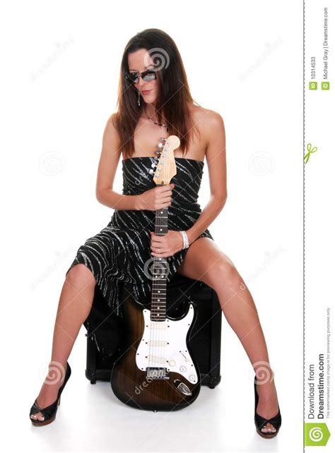 brunette teasing and holding a guitar stock image image